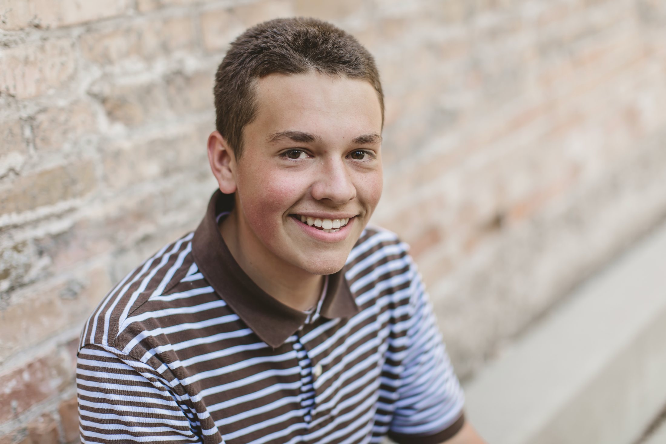 Isaac smiling in a striped shirt